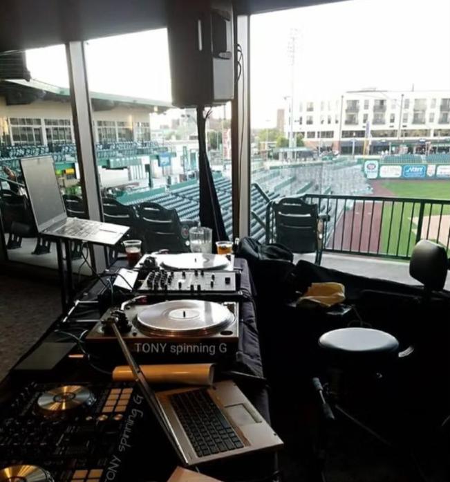 DJ booth set up in a ballpark suite overlooking the field