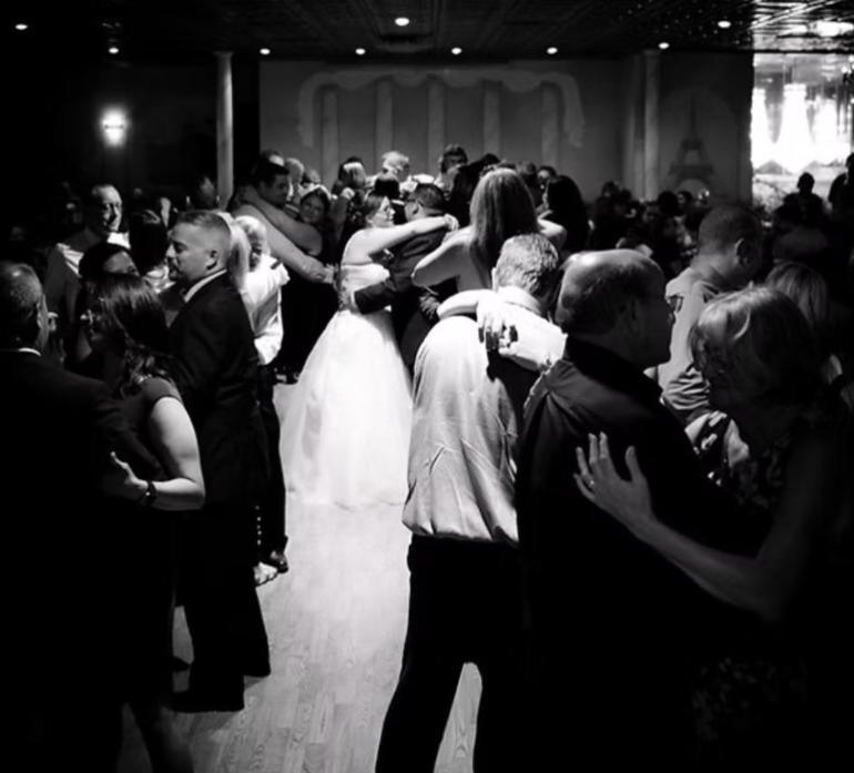 Wedding guests slow dancing around the bride